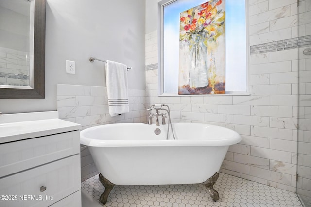 828 Lotus Ln N, Saint Johns, FL 32259 - full bath featuring tile walls, vanity, a freestanding bath, and tile patterned floors