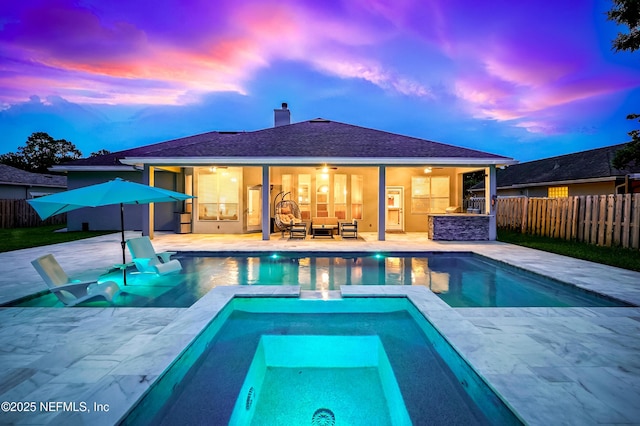 828 Lotus Ln N, Saint Johns, FL 32259 - pool at dusk featuring ceiling fan, a fenced backyard, outdoor lounge area, an in-ground hot tub, and a patio area