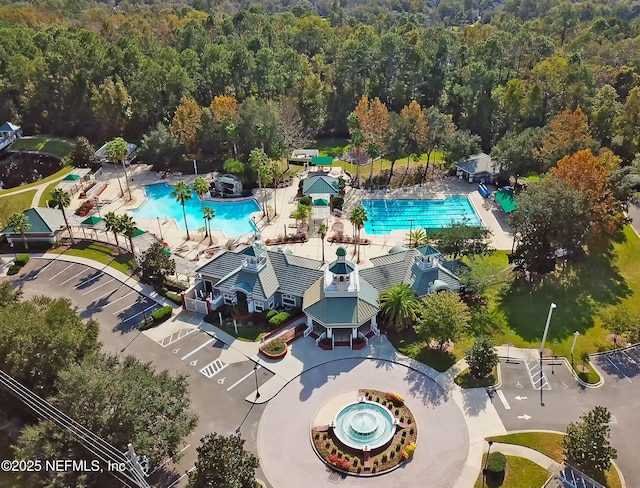 828 Lotus Ln N, Saint Johns, FL 32259 - drone / aerial view of a pool and a heavily wooded area