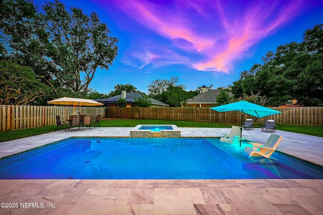 828 Lotus Ln N, Saint Johns, FL 32259 - pool at dusk featuring an in-ground hot tub, a patio area, a fenced backyard, and outdoor dining space