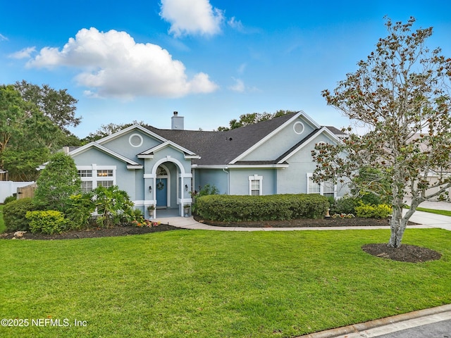 828 Lotus Ln N, Saint Johns, FL 32259 - ranch-style house with stucco siding, a chimney, a front lawn, and a shingled roof