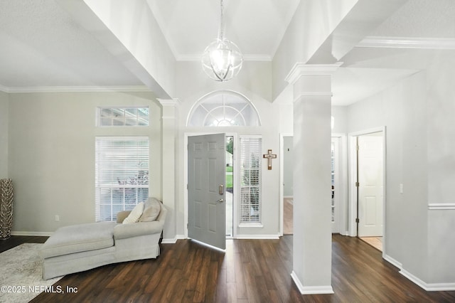 828 Lotus Ln N, Saint Johns, FL 32259 - entryway with ornate columns, dark wood finished floors, baseboards, crown molding, and a chandelier