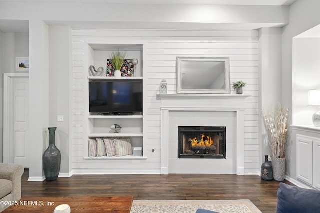 828 Lotus Ln N, Saint Johns, FL 32259 - living area with wood finished floors, a tiled fireplace, and baseboards