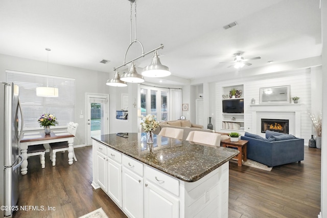 828 Lotus Ln N, Saint Johns, FL 32259 - kitchen featuring freestanding refrigerator, a center island, dark wood finished floors, ceiling fan, and white cabinets