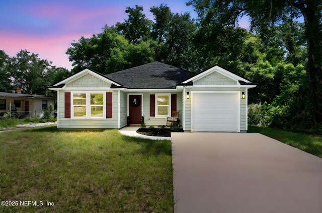 127 Azalea Cir, Palatka, FL 32177 - ranch-style house featuring driveway, a garage, a front lawn, and a shingled roof