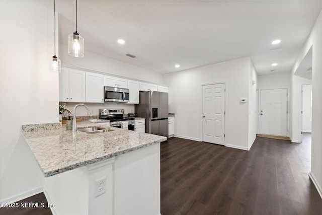 127 Azalea Cir, Palatka, FL 32177 - kitchen with stainless steel appliances, a sink, white cabinetry, light stone counters, and baseboards
