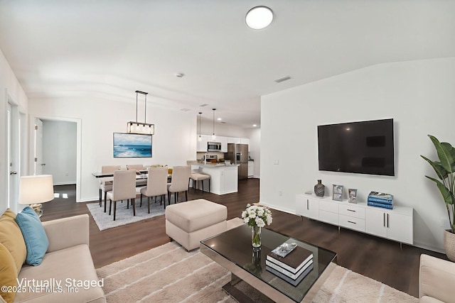 127 Azalea Cir, Palatka, FL 32177 - living room featuring dark wood finished floors and lofted ceiling