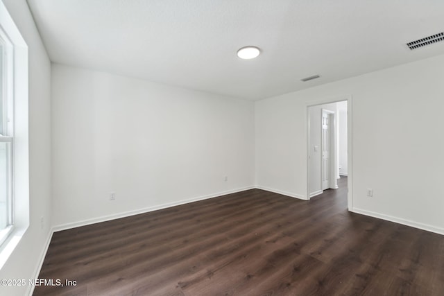 127 Azalea Cir, Palatka, FL 32177 - empty room featuring dark wood-style flooring and baseboards