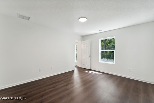 127 Azalea Cir, Palatka, FL 32177 - spare room featuring dark wood-type flooring and baseboards