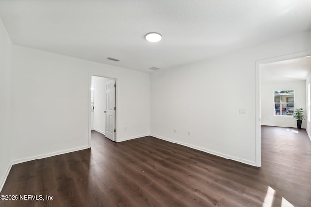 127 Azalea Cir, Palatka, FL 32177 - empty room featuring dark wood finished floors and baseboards