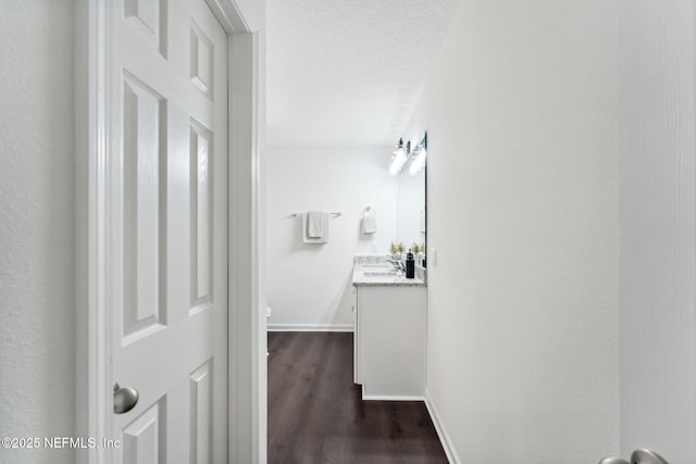 127 Azalea Cir, Palatka, FL 32177 - corridor featuring baseboards, dark wood-style flooring, and a sink