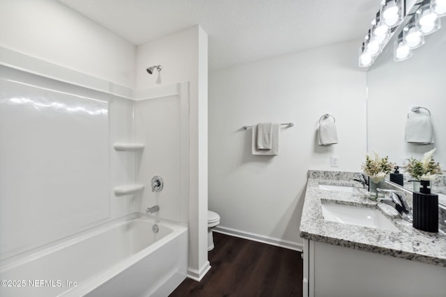 127 Azalea Cir, Palatka, FL 32177 - bathroom with double vanity, shower / bathtub combination, wood finished floors, toilet, and baseboards