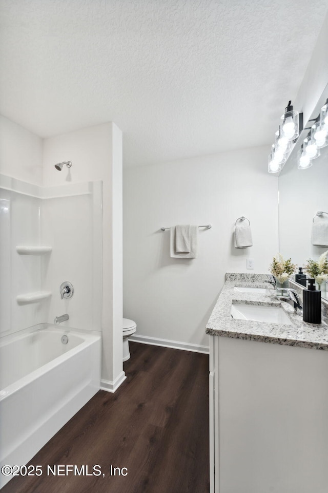 127 Azalea Cir, Palatka, FL 32177 - bathroom with toilet, wood finished floors, double vanity, bathing tub / shower combination, and baseboards