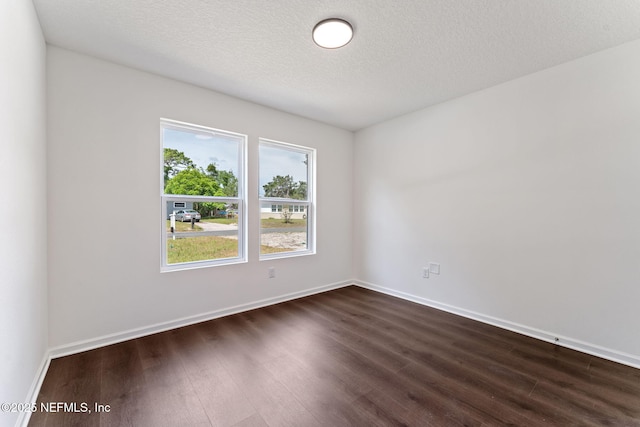 127 Azalea Cir, Palatka, FL 32177 - unfurnished room with dark wood-style floors, baseboards, and a textured ceiling