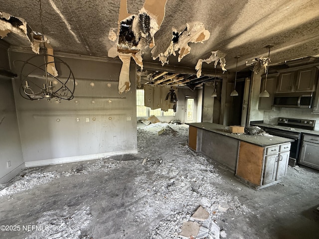 74 Conifer Cir, Middleburg, FL 32068 - kitchen with electric range, open floor plan, stainless steel microwave, a center island, and a chandelier