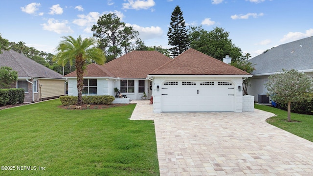 53 Waterbridge Pl, Ponte Vedra Beach, FL 32082 - view of front of property with a garage, a front lawn, decorative driveway, cooling unit, and a chimney