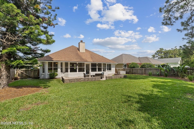 53 Waterbridge Pl, Ponte Vedra Beach, FL 32082 - back of house featuring a sunroom, a chimney, and roof with shingles