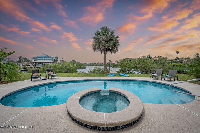 231 Barrataria Dr, Saint Augustine, FL 32080 - view of swimming pool with a patio, a pool with connected hot tub, a water view, and a lawn
