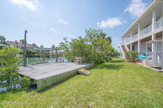 231 Barrataria Dr, Saint Augustine, FL 32080 - view of green lawn with a water view and a boat dock