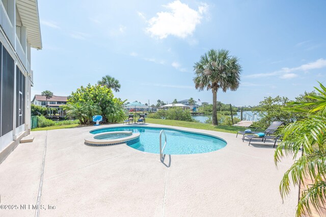 231 Barrataria Dr, Saint Augustine, FL 32080 - view of swimming pool featuring a patio area, a water view, and a pool with connected hot tub