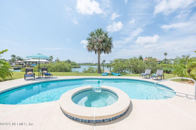 231 Barrataria Dr, Saint Augustine, FL 32080 - view of pool with a pool with connected hot tub, a patio, a water view, and a lawn