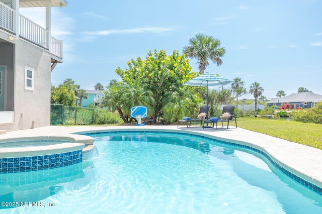 231 Barrataria Dr, Saint Augustine, FL 32080 - view of swimming pool featuring a pool with connected hot tub, a lawn, and a patio area