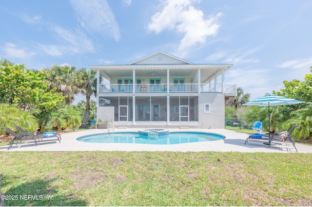 231 Barrataria Dr, Saint Augustine, FL 32080 - back of property with a balcony, a lawn, a ceiling fan, and a patio area