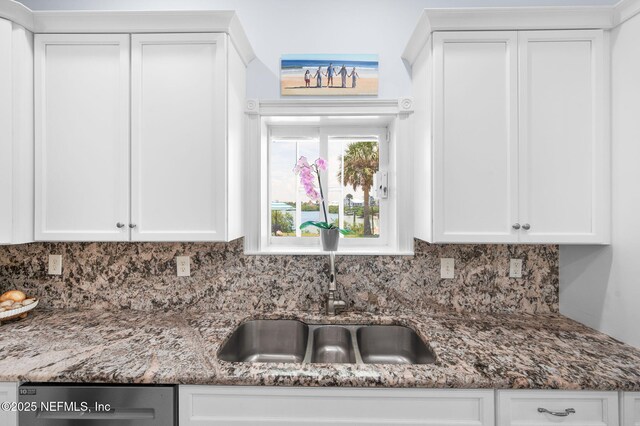 231 Barrataria Dr, Saint Augustine, FL 32080 - kitchen featuring stainless steel dishwasher, backsplash, and white cabinets