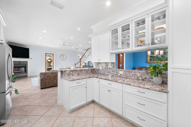 231 Barrataria Dr, Saint Augustine, FL 32080 - kitchen featuring freestanding refrigerator, light tile patterned flooring, open floor plan, recessed lighting, and white cabinets