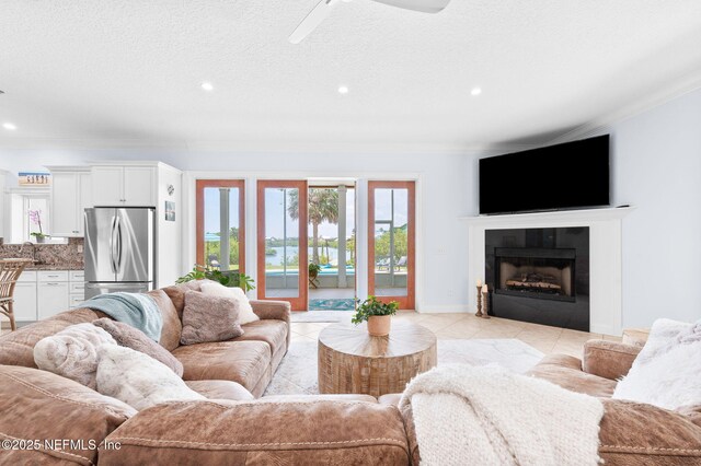 231 Barrataria Dr, Saint Augustine, FL 32080 - living area featuring ceiling fan, ornamental molding, recessed lighting, light tile patterned flooring, and a fireplace