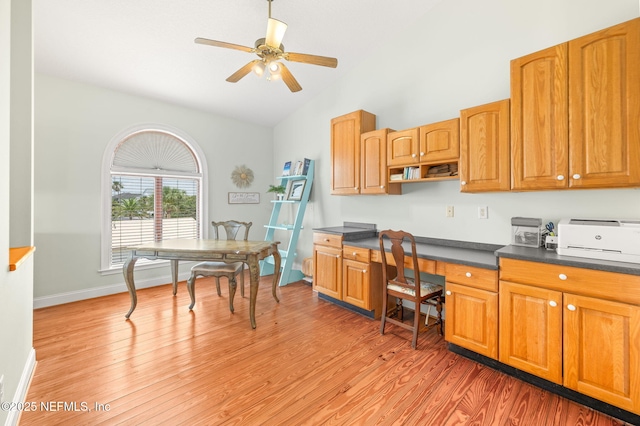 231 Barrataria Dr, Saint Augustine, FL 32080 - kitchen with dark countertops, lofted ceiling, ceiling fan, a desk, and light wood-type flooring