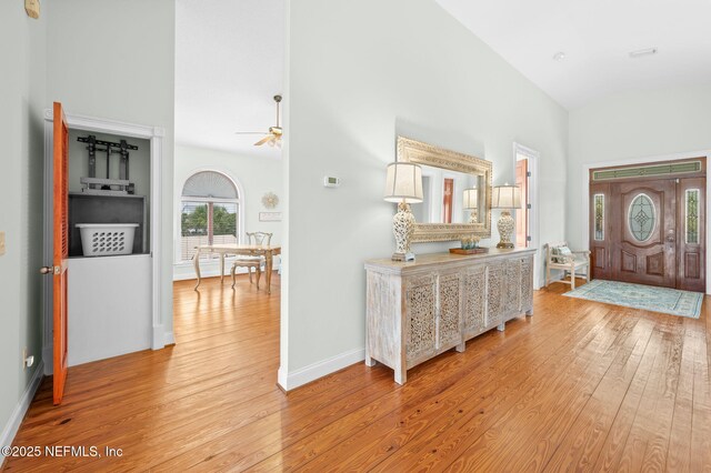 231 Barrataria Dr, Saint Augustine, FL 32080 - entrance foyer with light wood-style flooring, high vaulted ceiling, ceiling fan, and baseboards