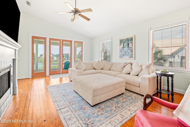 231 Barrataria Dr, Saint Augustine, FL 32080 - living area with healthy amount of natural light, a ceiling fan, light wood finished floors, vaulted ceiling, and a tiled fireplace