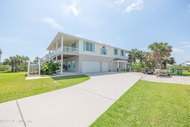 231 Barrataria Dr, Saint Augustine, FL 32080 - view of front of house featuring a garage, a front yard, stucco siding, stairway, and driveway