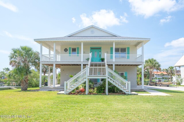 231 Barrataria Dr, Saint Augustine, FL 32080 - beach home with stairs, covered porch, and a front yard