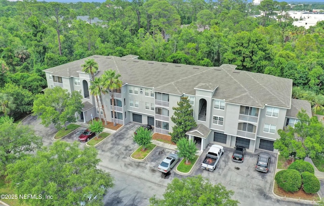 425 S Villa San Marco Dr Unit 302, Saint Augustine, FL 32086 - view of building exterior with a view of trees and uncovered parking
