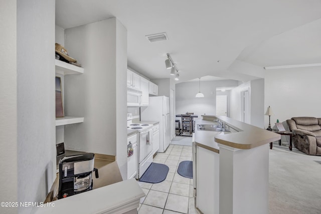 425 S Villa San Marco Dr Unit 302, Saint Augustine, FL 32086 - kitchen with white appliances, a sink, white cabinets, a kitchen island with sink, and rail lighting