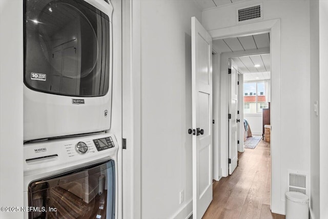 901 Ocean Blvd Unit 91, Atlantic Beach, FL 32233 - laundry room featuring stacked washing machine and dryer and wood finished floors