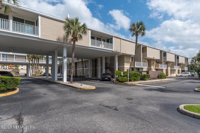 901 Ocean Blvd Unit 91, Atlantic Beach, FL 32233 - view of property featuring covered and uncovered parking and a residential view