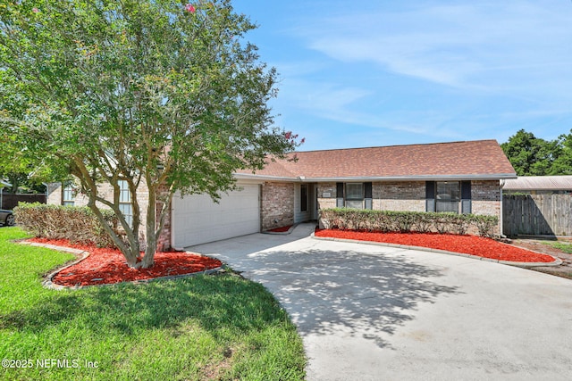 2650 Cardigan Ct, Orange Park, FL 32065 - view of front facade with driveway, an attached garage, brick siding, and roof with shingles