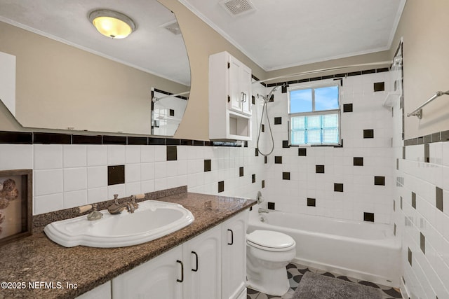 2650 Cardigan Ct, Orange Park, FL 32065 - full bathroom featuring tile walls, toilet, vanity, bathtub / shower combination, and crown molding