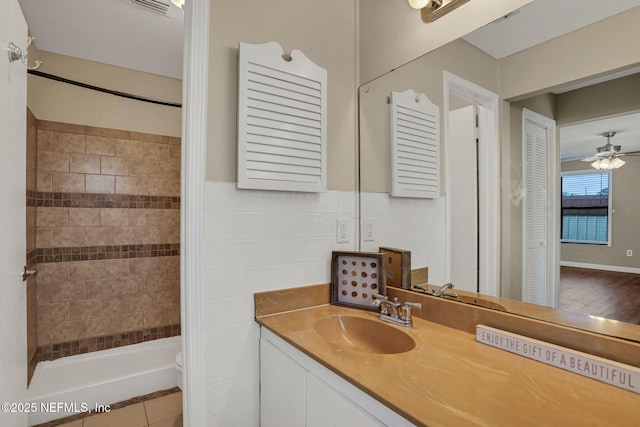 2650 Cardigan Ct, Orange Park, FL 32065 - bathroom with a tile shower, vanity, toilet, ceiling fan, and tile patterned flooring