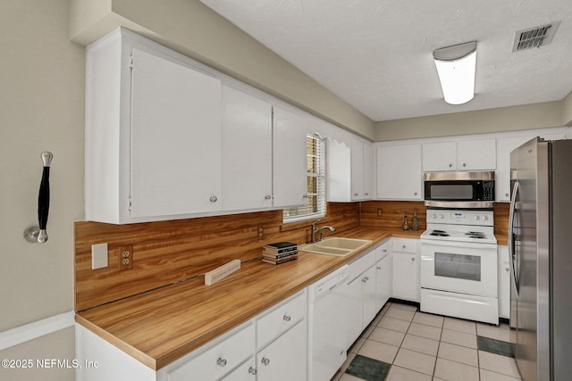 2650 Cardigan Ct, Orange Park, FL 32065 - kitchen with appliances with stainless steel finishes, a sink, white cabinetry, tasteful backsplash, and light countertops