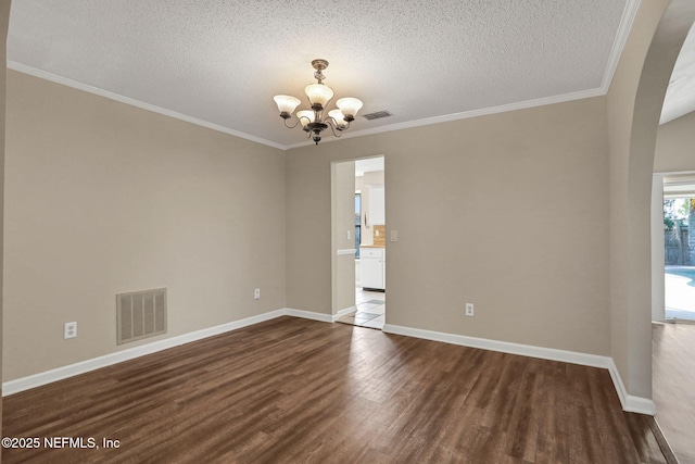 2650 Cardigan Ct, Orange Park, FL 32065 - unfurnished room featuring a chandelier, dark wood-style flooring, a textured ceiling, baseboards, and ornamental molding