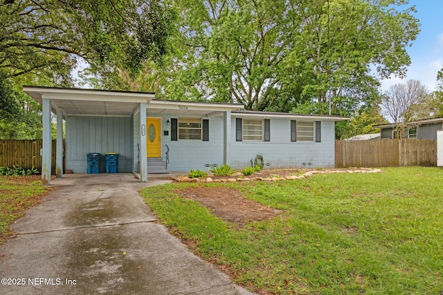 7456 Burlingame Dr S, Jacksonville, FL 32211 - view of front of property featuring concrete driveway, an attached carport, and board and batten siding