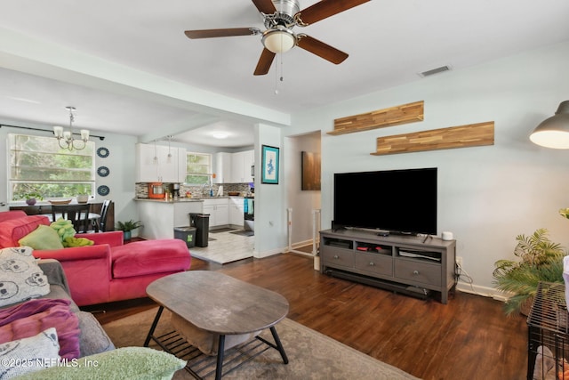 7456 Burlingame Dr S, Jacksonville, FL 32211 - living area featuring dark wood-style floors, a ceiling fan, baseboards, and a chandelier