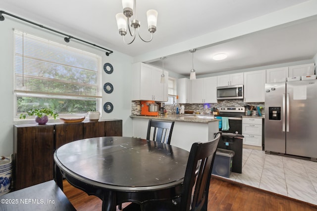 7456 Burlingame Dr S, Jacksonville, FL 32211 - dining room featuring a chandelier