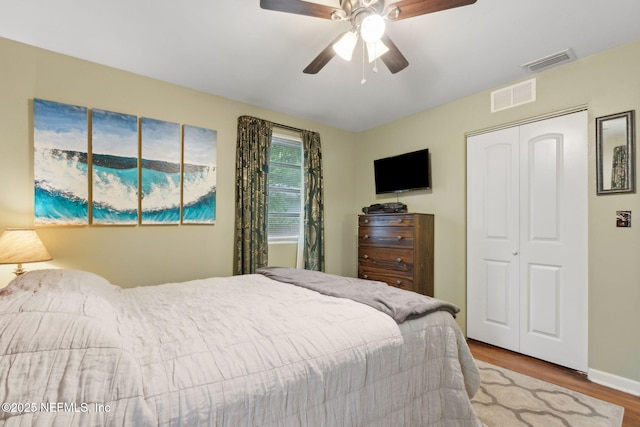 7456 Burlingame Dr S, Jacksonville, FL 32211 - bedroom with wood finished floors, a closet, ceiling fan, and baseboards