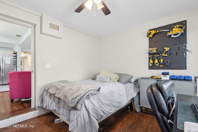 7456 Burlingame Dr S, Jacksonville, FL 32211 - bedroom featuring stainless steel refrigerator with ice dispenser, wood finished floors, and a ceiling fan