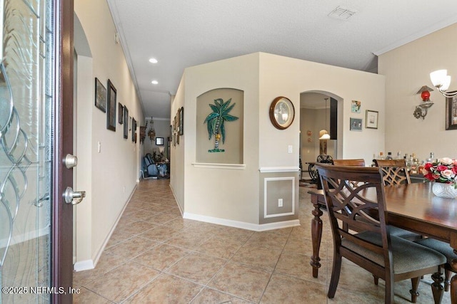3912 Pipit Pt, Middleburg, FL 32068 - dining space featuring arched walkways, light tile patterned floors, ornamental molding, baseboards, and recessed lighting
